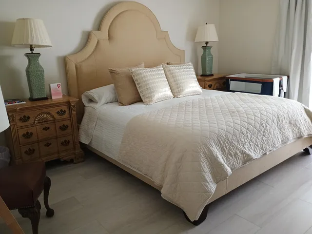 a bedroom with a bed and a mirror