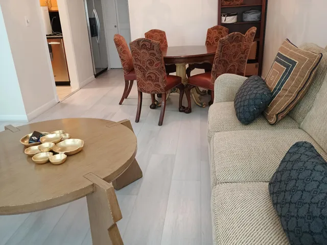 a dining room with furniture and wooden floor