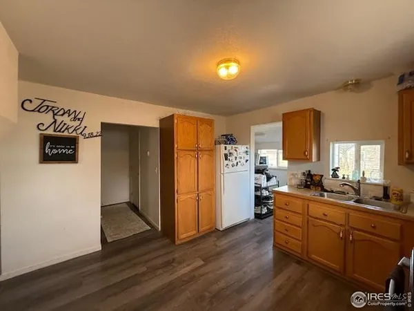 a kitchen with sink refrigerator and cabinets