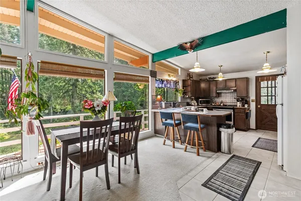 a dining area with furniture and a kitchen view