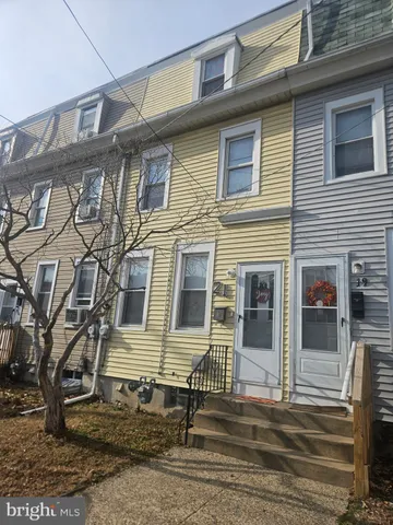 a view of a brick house with many windows