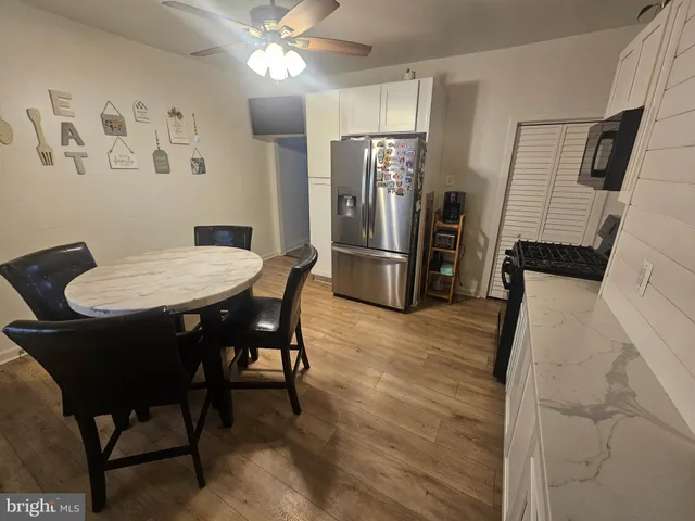 a view of a dining room with furniture and a chandelier