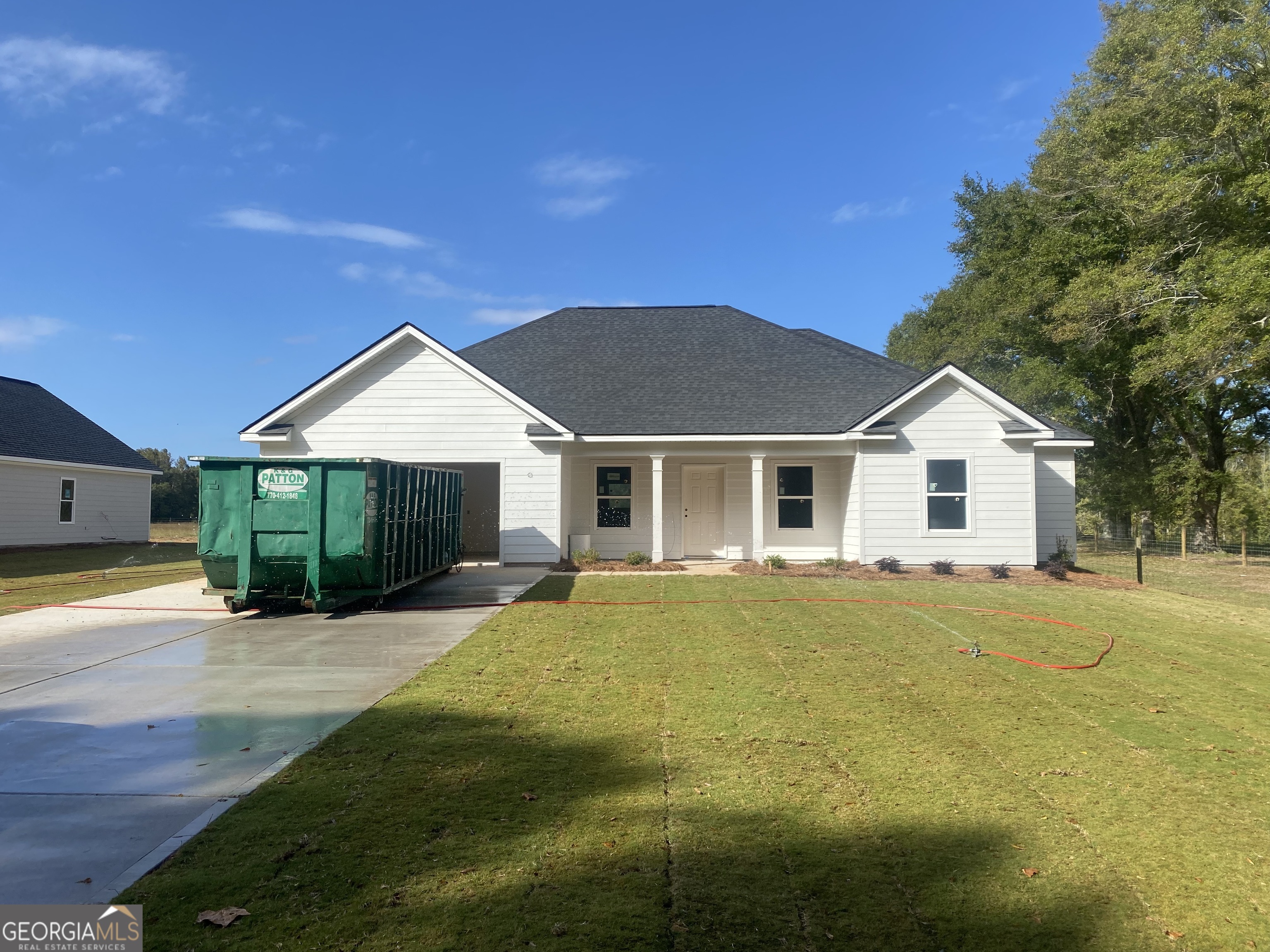 168 Mathews Road Milner, GA 30257 - Photo 1 of 14 a front view of a house with a yard and garage