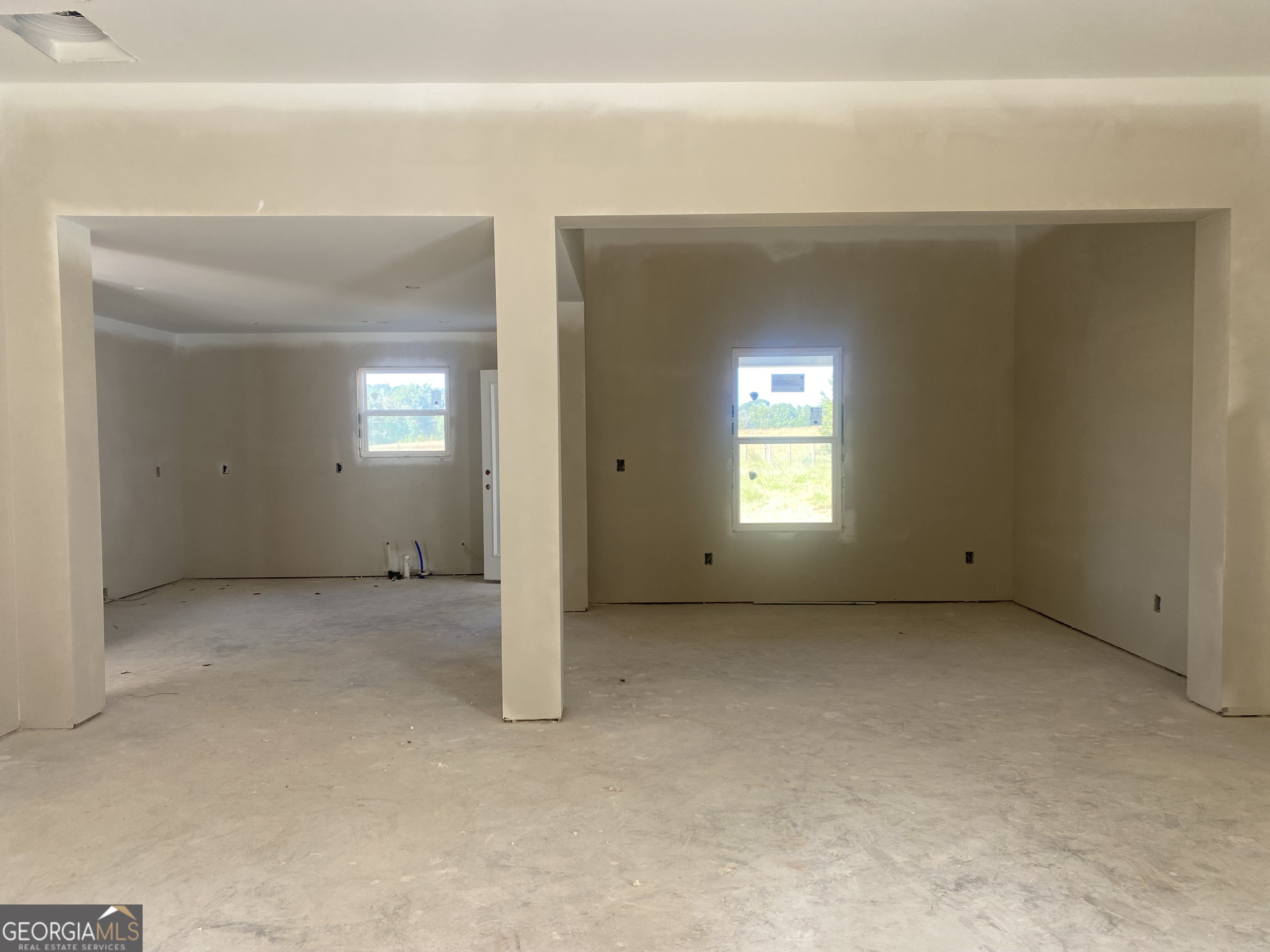 168 Mathews Road Milner, GA 30257 - Photo 3 of 14 a view of an empty room with a fireplace and a window