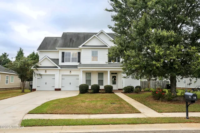 a view of a white house with a outdoor space