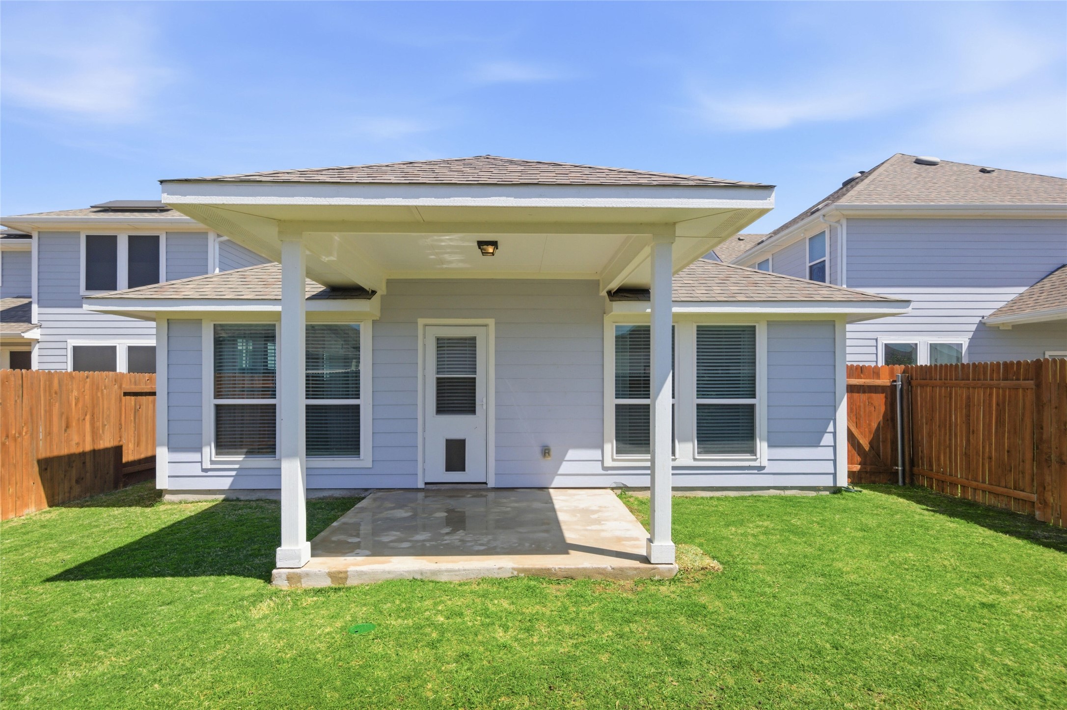 269 Gaida Loop Georgetown, TX 78628 - Photo 18 of 20 Back of house featuring a shingled roof, a patio area, and a fenced backyard