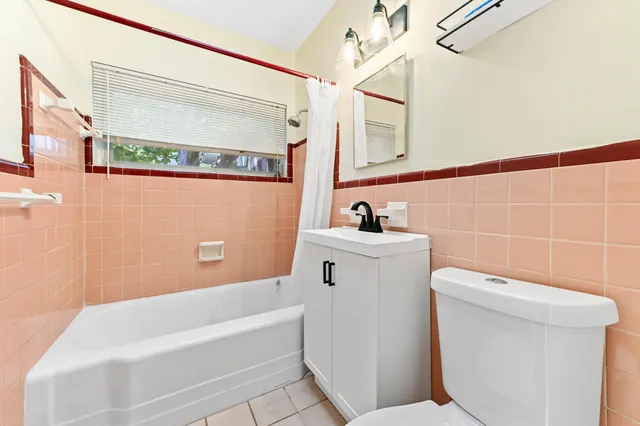a bathroom with a toilet and a bathtub