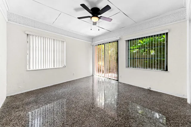 a view of a livingroom with a ceiling fan and window