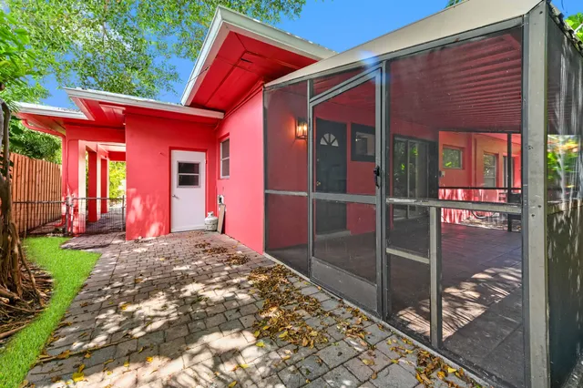 a backyard of a house with barbeque oven table and chairs