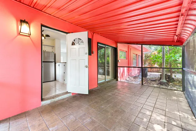 a view of a porch with a table and chairs