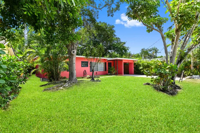 a view of backyard with swimming pool and green space