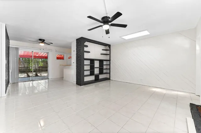 a view of an empty room with a ceiling fan