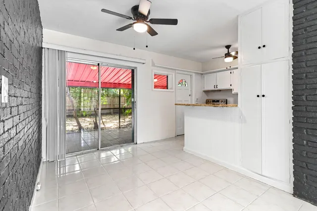 a open kitchen with cabinets a stove and a window