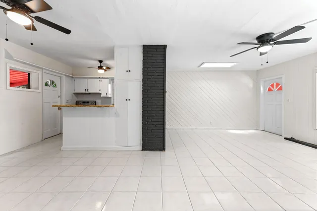a view of a livingroom with kitchen and furniture