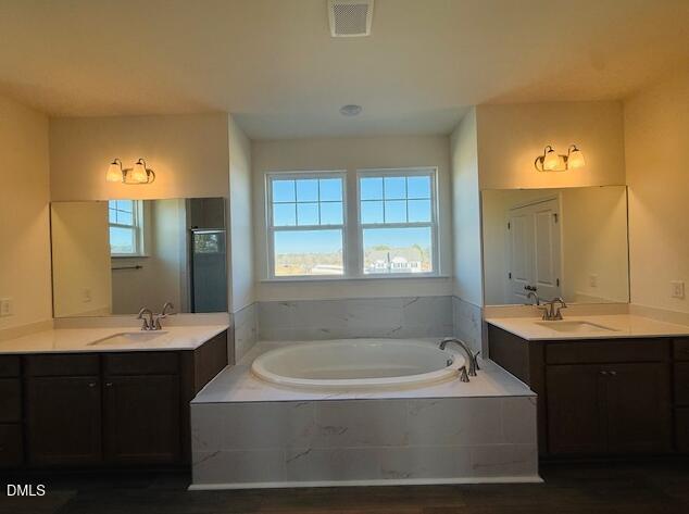 76 Alden Way Angier, NC 27501 - Photo 16 of 25 a bathroom with a tub sink and mirror