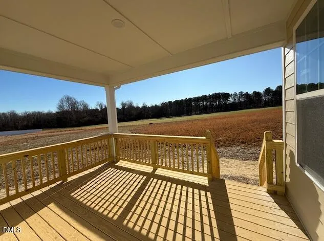 a view of balcony with wooden floor and ocean view
