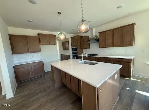 a kitchen with a sink cabinets and wooden floor