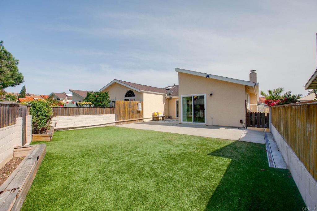 a view of a house with backyard and a patio