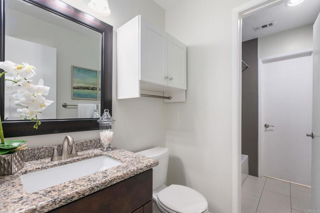 810 Caminito Del Mar Carlsbad, CA 92011 - Photo 15 of 30 a bathroom with a granite countertop sink toilet and mirror