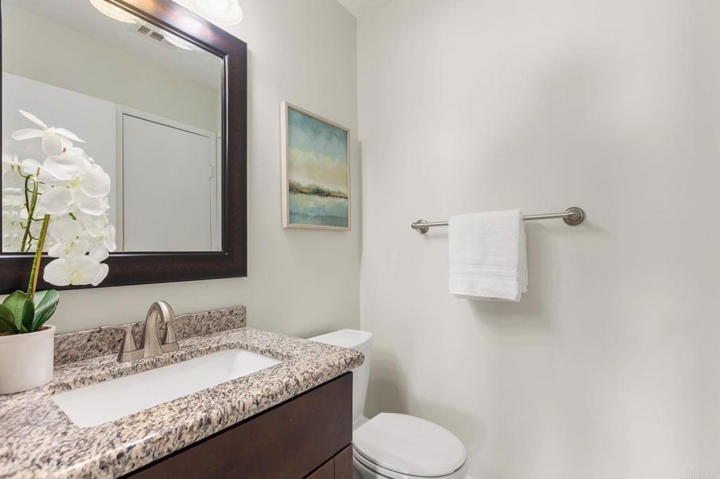 810 Caminito Del Mar Carlsbad, CA 92011 - Photo 18 of 30 a bathroom with a granite countertop sink toilet and mirror