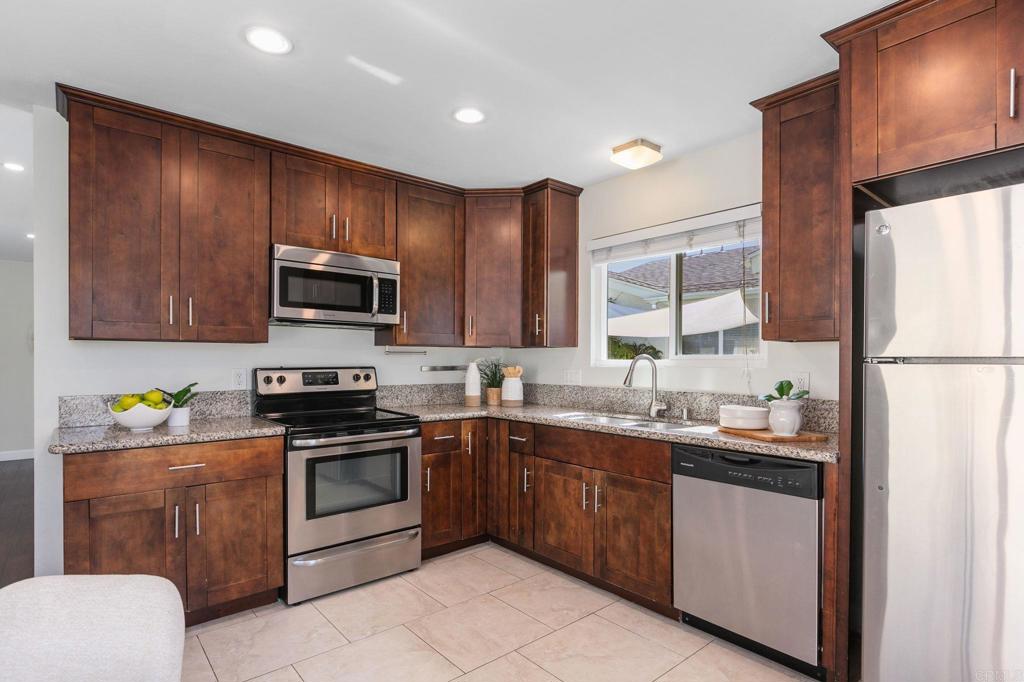 810 Caminito Del Mar Carlsbad, CA 92011 - Photo 10 of 30 a kitchen with a sink stainless steel appliances and cabinets