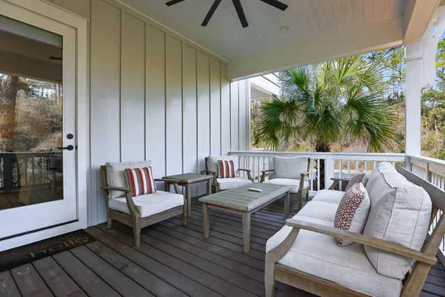 a view of a balcony with furniture and wooden floor
