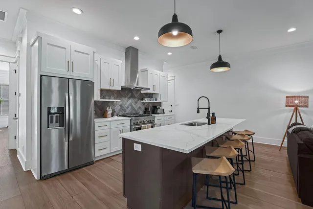 a living room with furniture and kitchen view