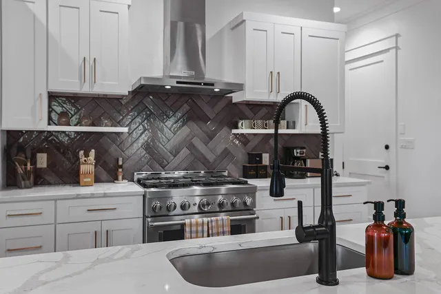 a view of living room with stainless steel appliances granite countertop furniture and a wooden floor
