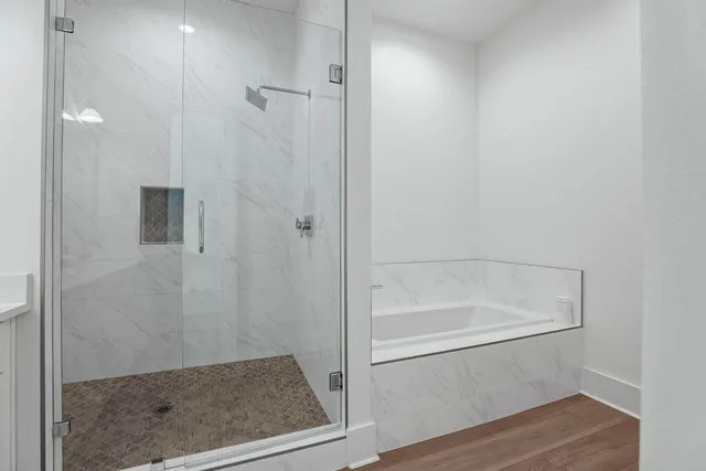 a bedroom with a bed and windows