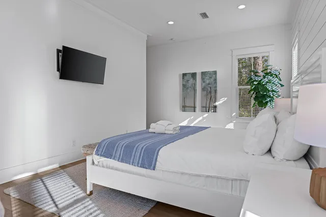 a bedroom with a bed and a flat screen tv