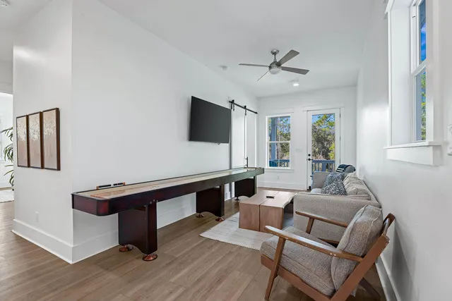 a bedroom with a large bed chandelier and a window