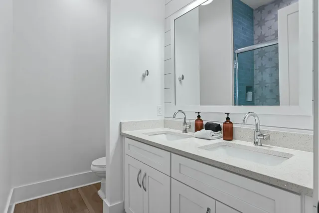 a bedroom with a large bed mirror and a window