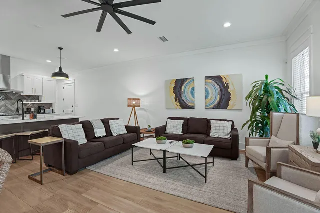 a living room with furniture and kitchen view