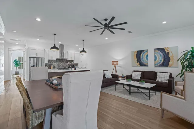 a roof deck with couches and wooden floor