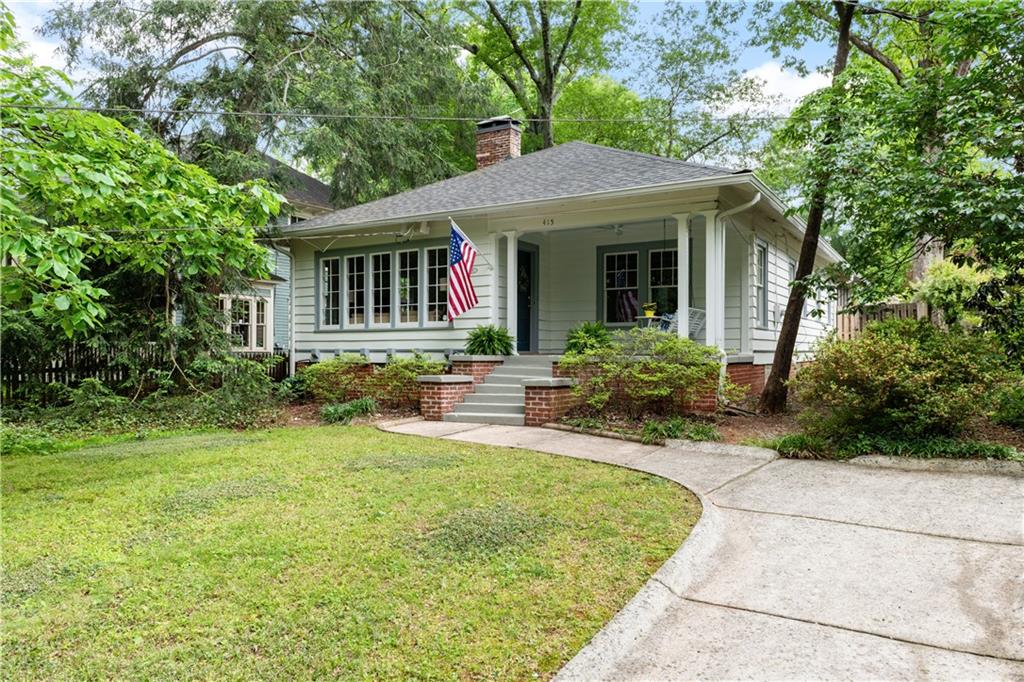 a view of a house with backyard sitting area and garden
