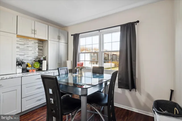 a view of a dining room with furniture and window