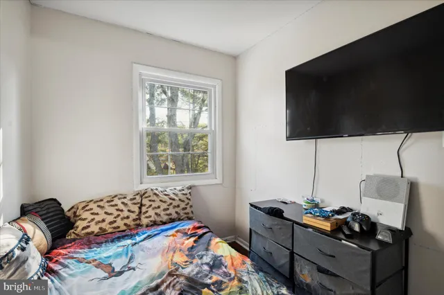 a bedroom with a bed and flat screen tv
