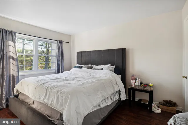 a bed sitting in a bedroom next to a window