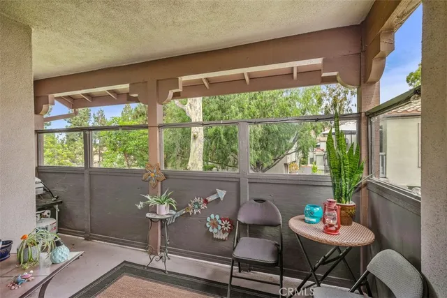 a outdoor living room with furniture and a window