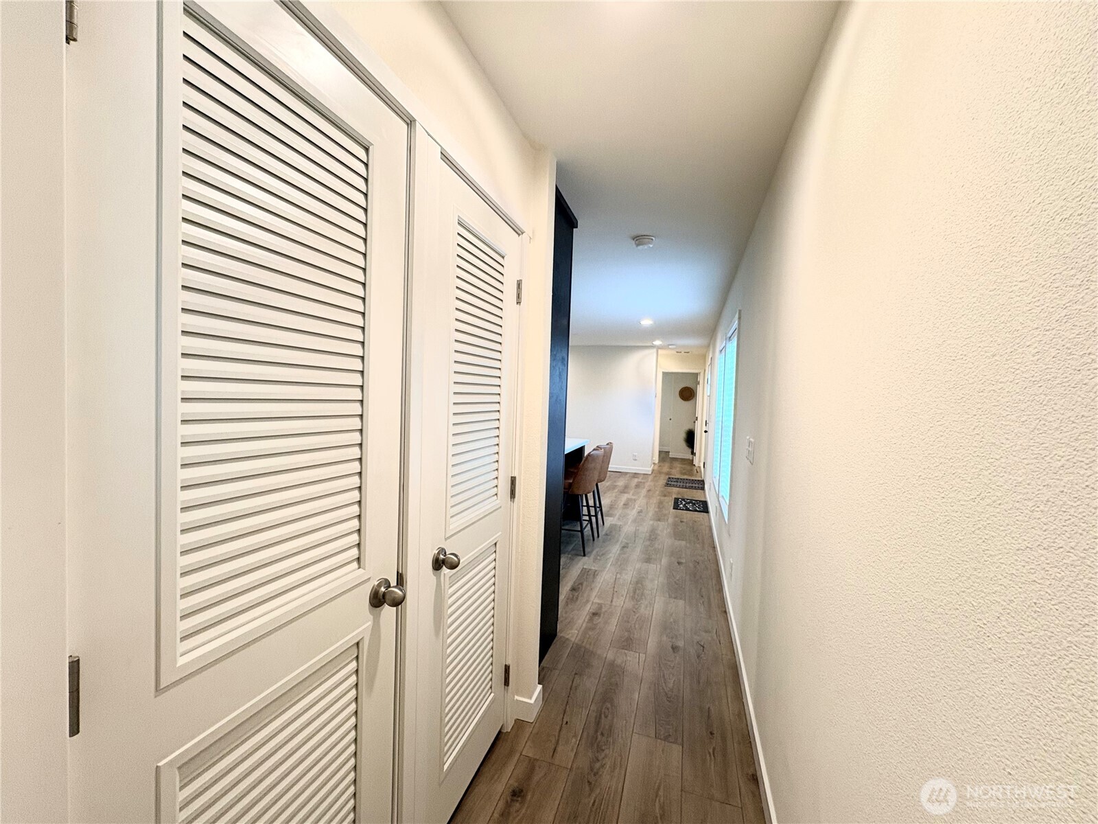 763 Eadon Road Toledo, WA 98591 - Photo 16 of 28 a view of a hallway with wooden floor and a bathroom
