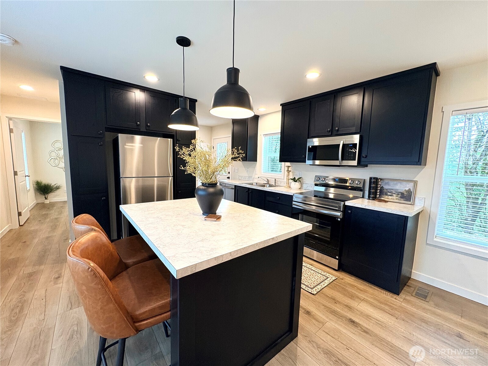763 Eadon Road Toledo, WA 98591 - Photo 5 of 28 a kitchen with a chandelier a sink stainless steel appliances and cabinets
