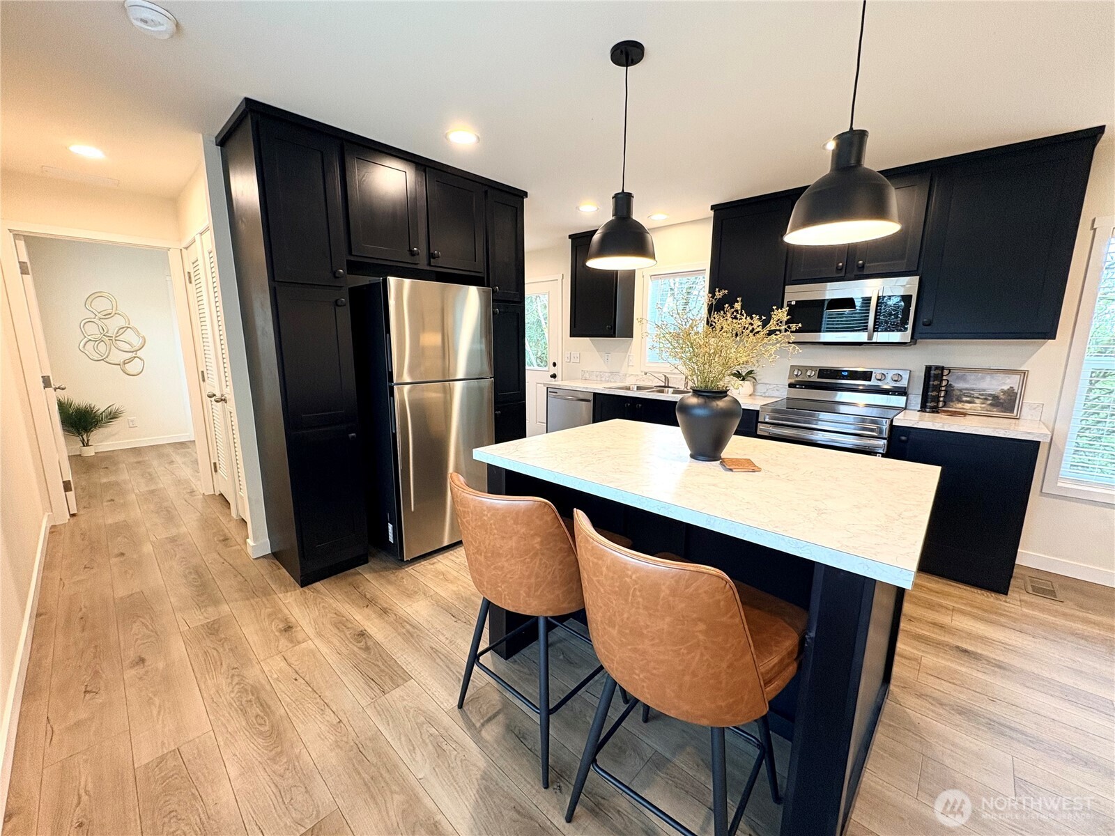 763 Eadon Road Toledo, WA 98591 - Photo 7 of 28 a kitchen with stainless steel appliances kitchen island granite countertop a table chairs and a refrigerator
