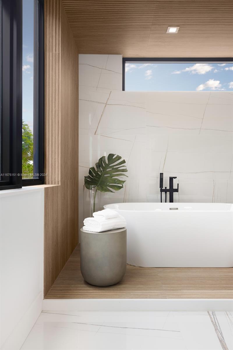 7425 Southwest 136th Street Pinecrest, FL 33156 - Photo 41 of 60 a white bath tub sitting in a bathroom