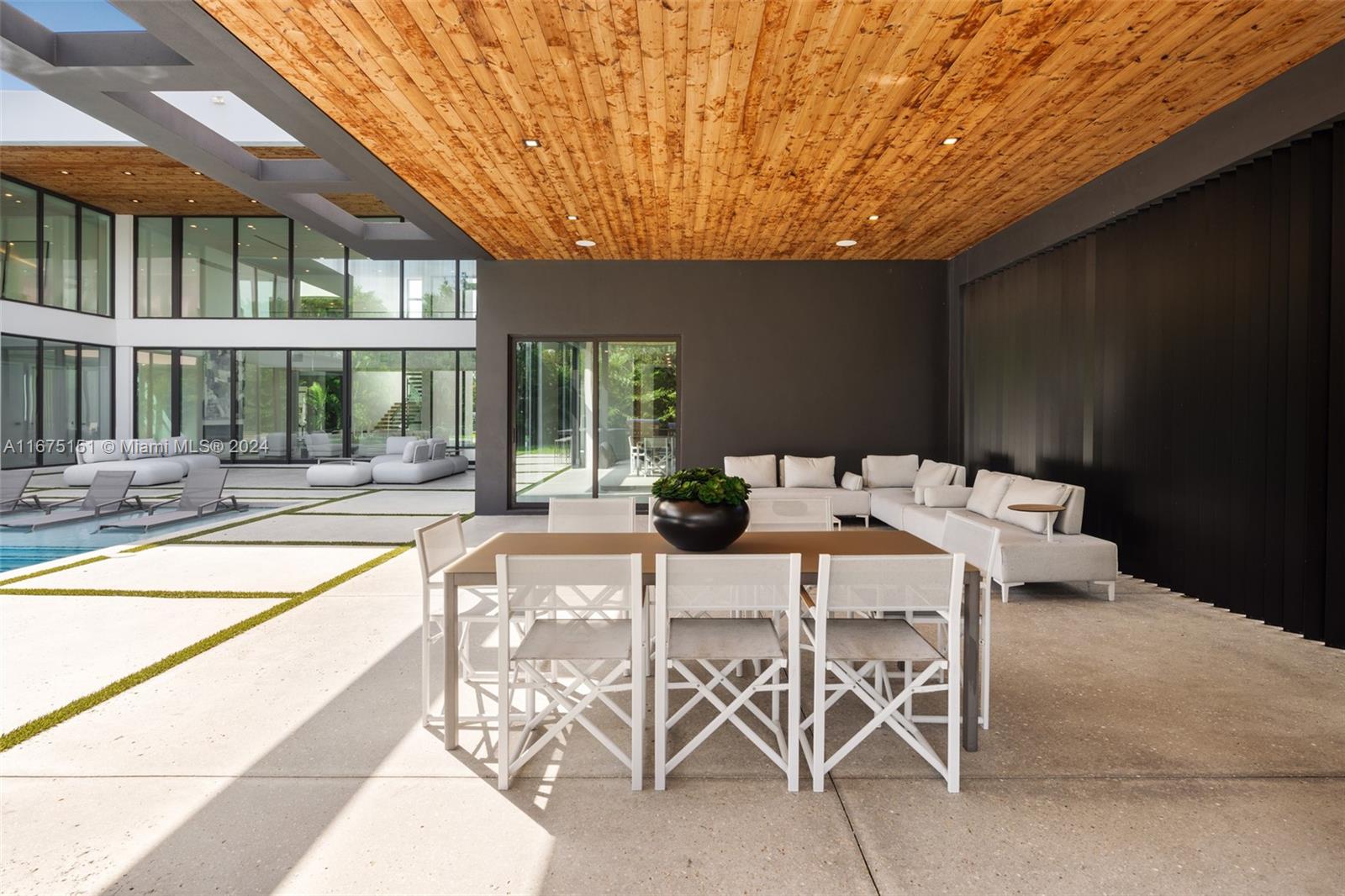 7425 Southwest 136th Street Pinecrest, FL 33156 - Photo 56 of 60 a view of a patio with table and chairs and potted plants