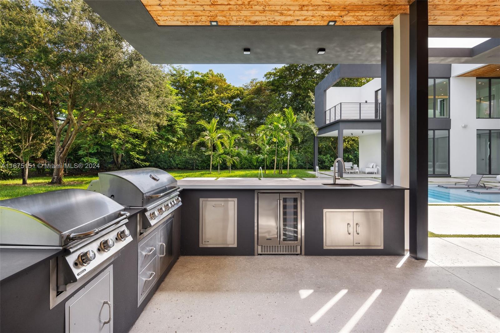 7425 Southwest 136th Street Pinecrest, FL 33156 - Photo 57 of 60 a view of a terrace with a garden