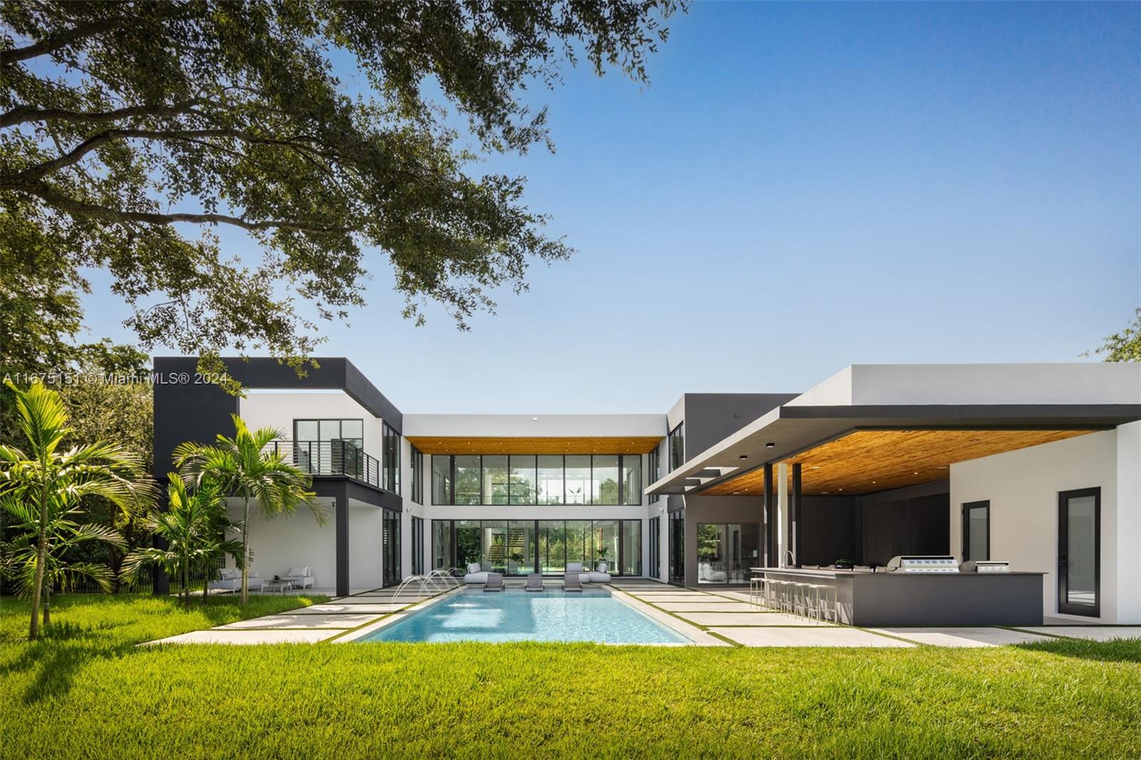 7425 Southwest 136th Street Pinecrest, FL 33156 - Photo 59 of 60 a front view of building with an outdoor space