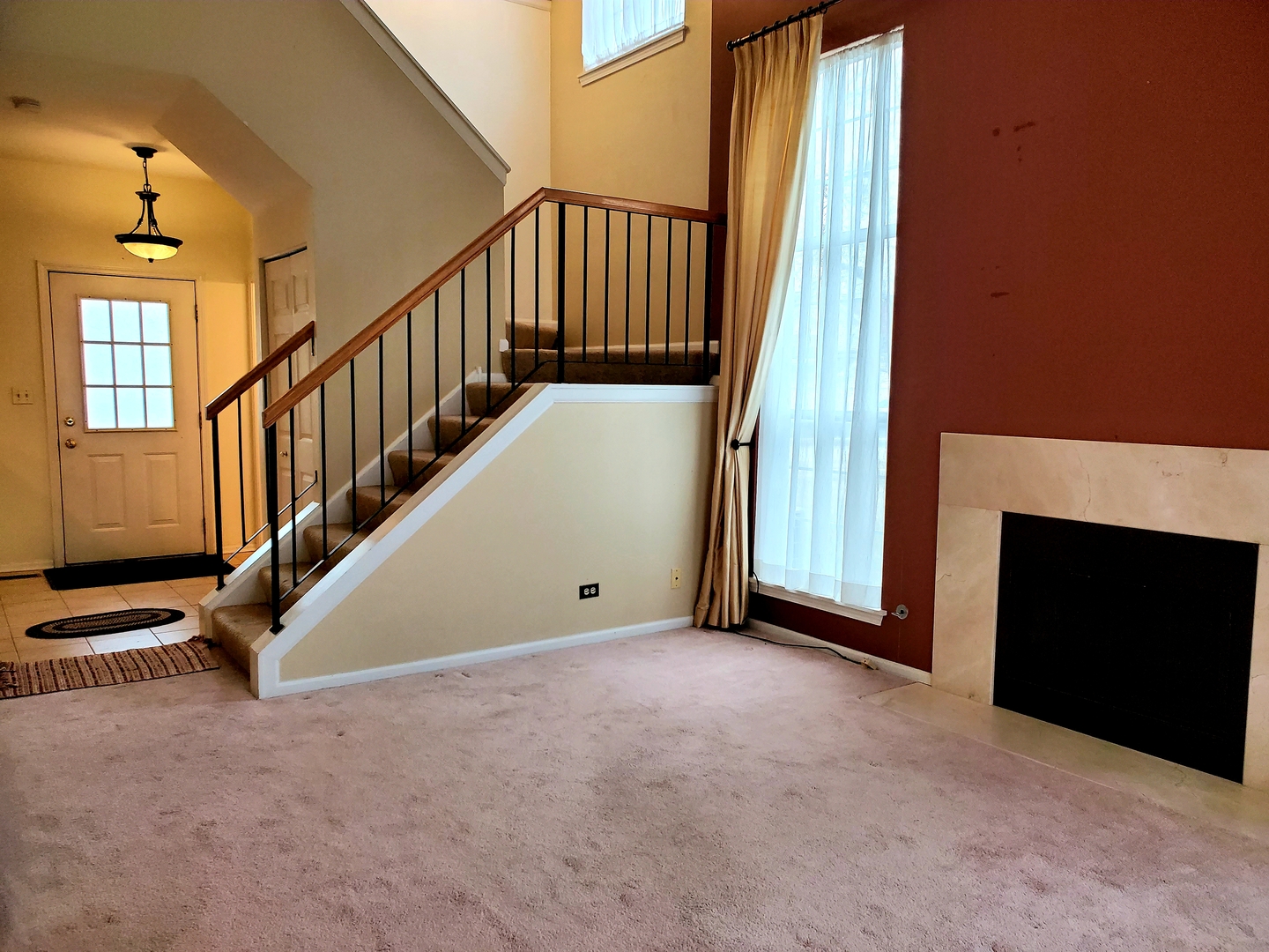 17857 Braewick Road Gurnee, IL 60031 - Photo 22 of 24 a view of an empty room with stairs and a fireplace