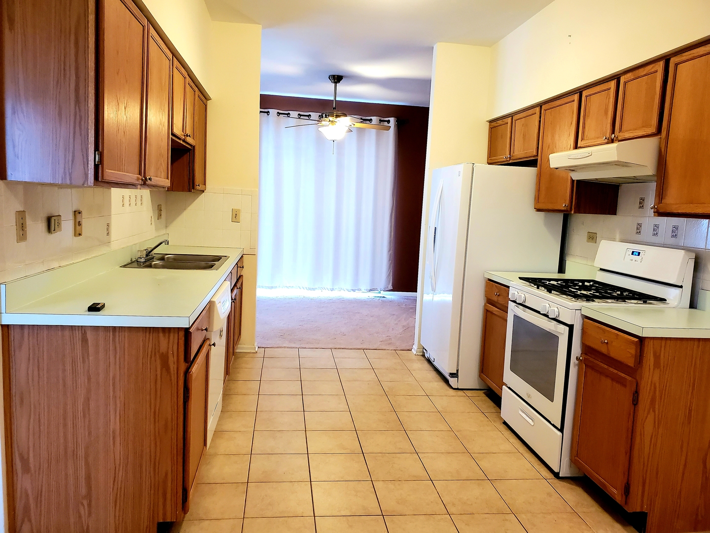 17857 Braewick Road Gurnee, IL 60031 - Photo 7 of 24 a kitchen with a sink a stove and a refrigerator