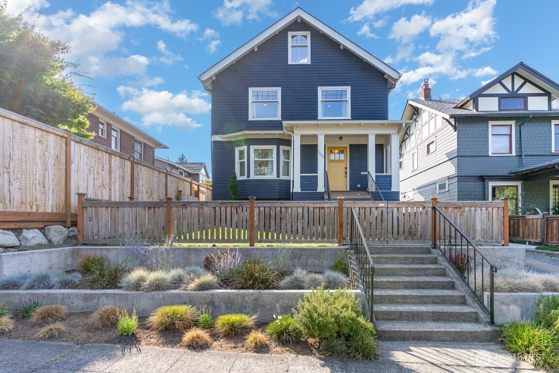 a front view of a house with a garden