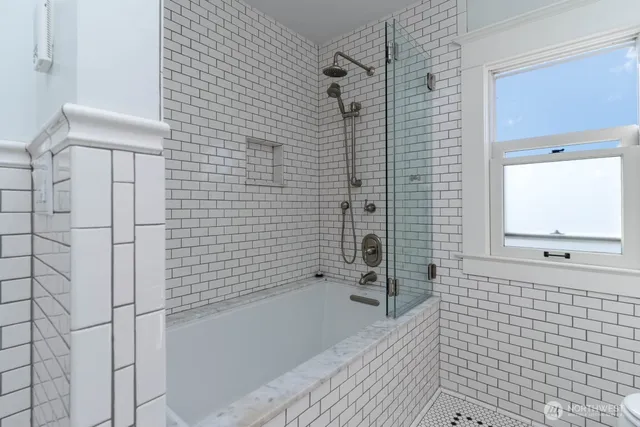 a bathroom with a bathtub and shower